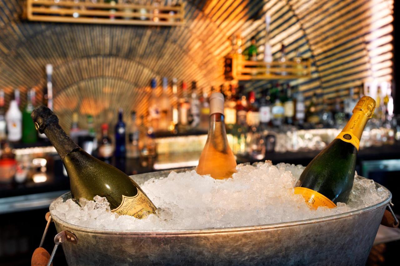 Moevenpick Hotel Bahrain Muharraq Exterior photo Champagne bottles in a champagne bucket