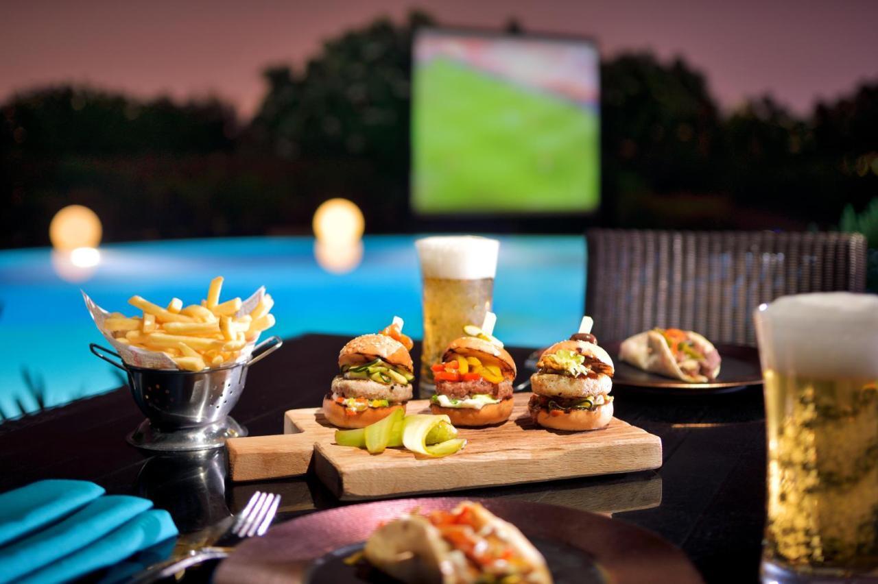 Moevenpick Hotel Bahrain Muharraq Exterior photo A typical sports bar