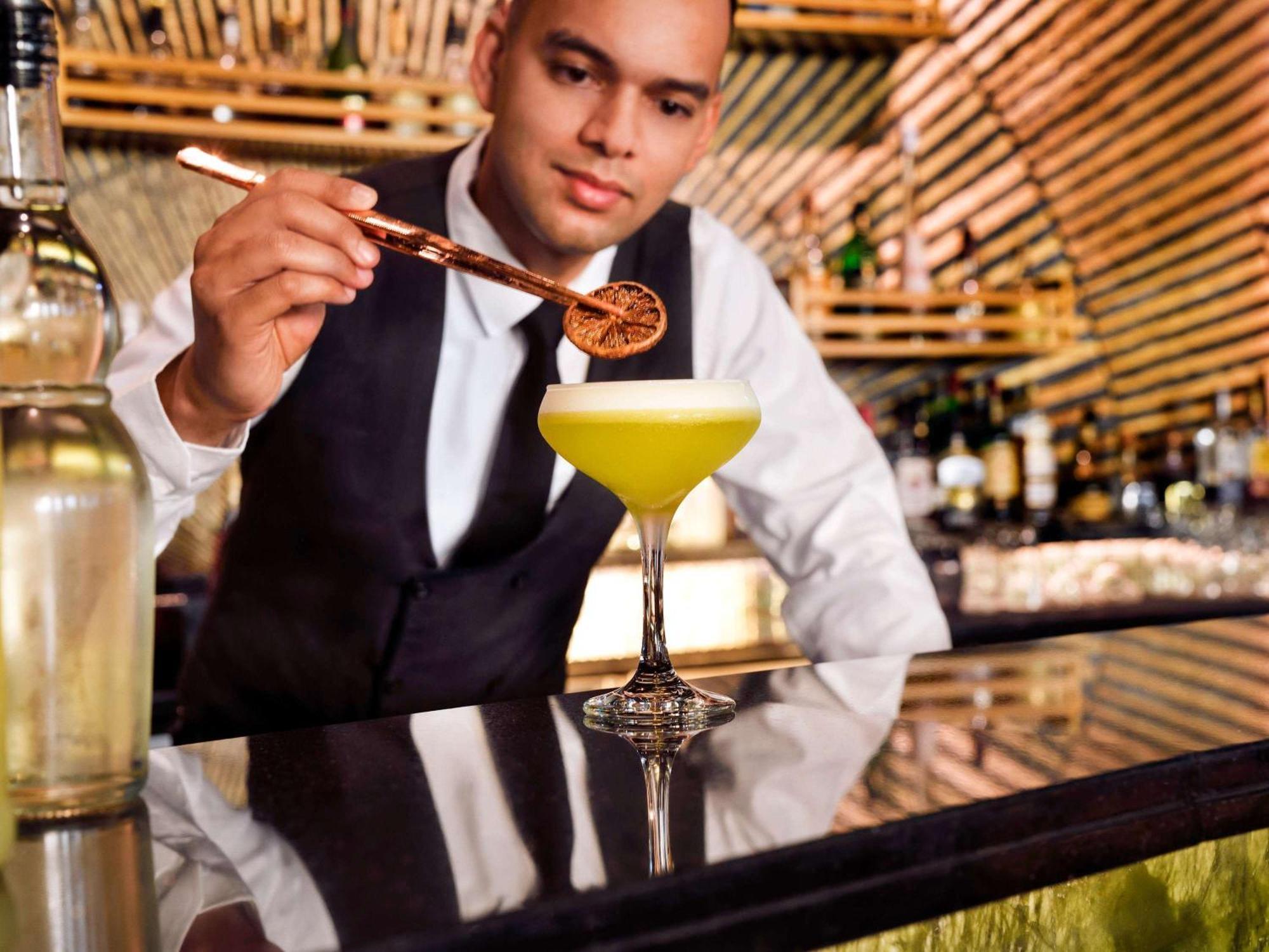 Moevenpick Hotel Bahrain Muharraq Exterior photo A bartender at work